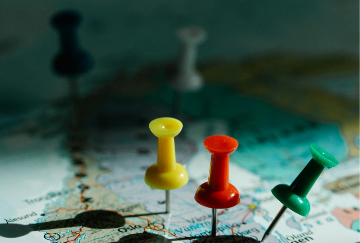Pushpins on a world map representing global trade and sourcing strategy